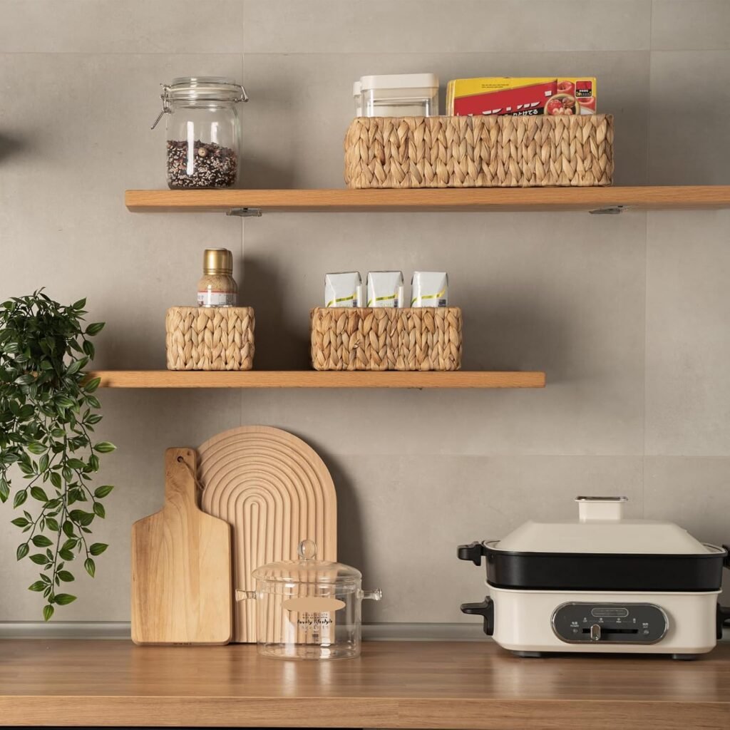 Natural water-hyacinth baskets displayed on open pantry shelves for neutral home organization